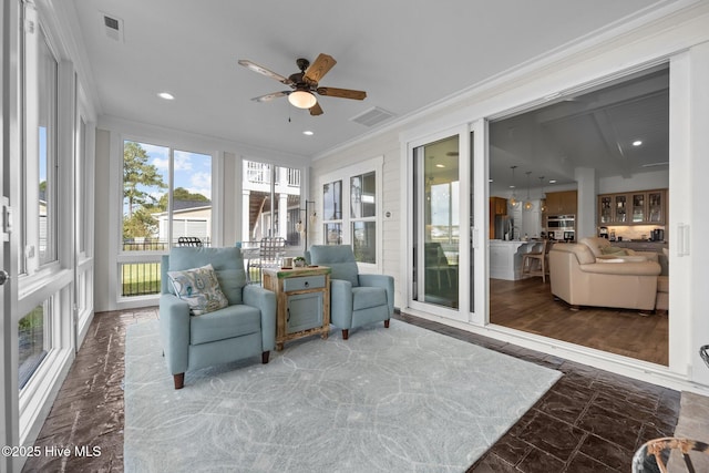 sunroom / solarium with ceiling fan