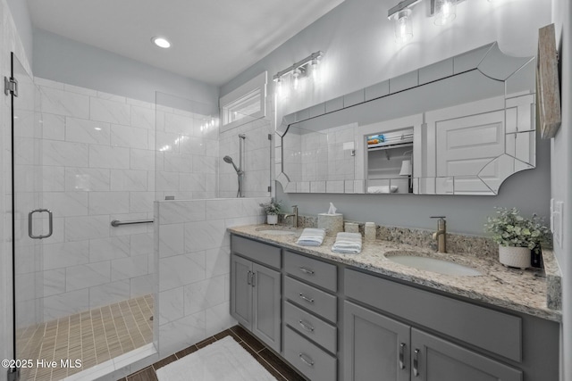 bathroom with a shower with door and vanity