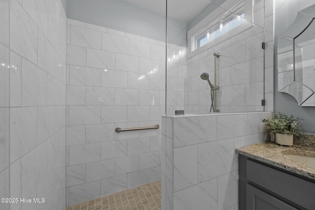 bathroom with vanity and tiled shower