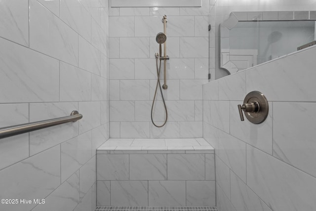 bathroom with a tile shower