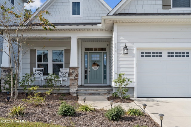 doorway to property featuring a garage and a porch