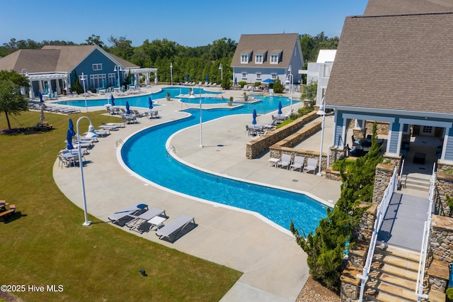 view of pool featuring a patio area and a lawn