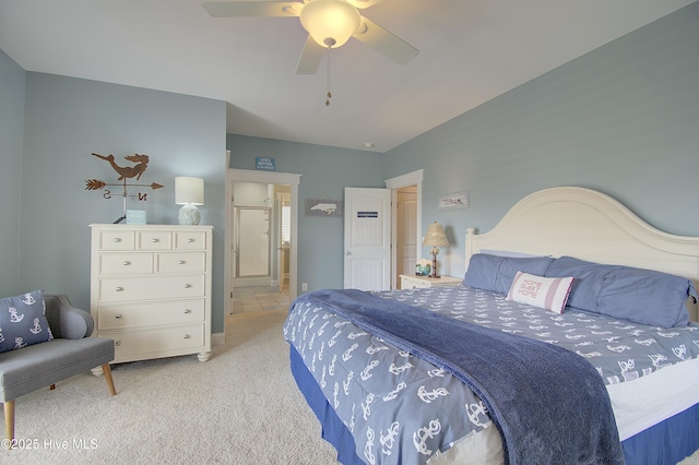 bedroom featuring ensuite bathroom, light carpet, and ceiling fan