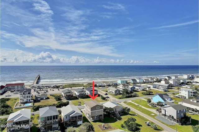 drone / aerial view featuring a water view and a view of the beach