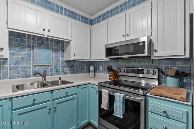 kitchen with blue cabinets, sink, tasteful backsplash, crown molding, and stainless steel appliances