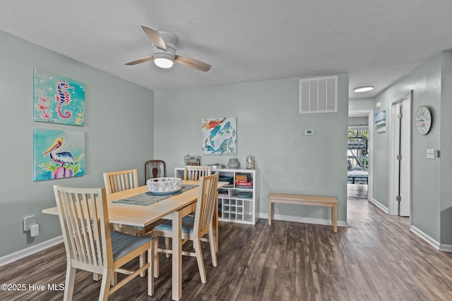 dining room featuring ceiling fan, dark hardwood / wood-style floors, and a textured ceiling