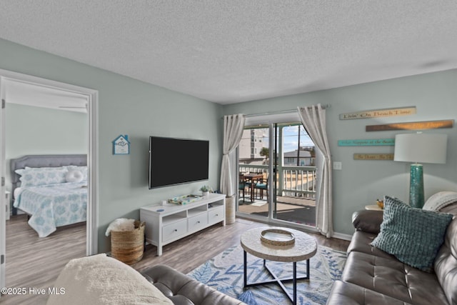 living room featuring hardwood / wood-style flooring and a textured ceiling