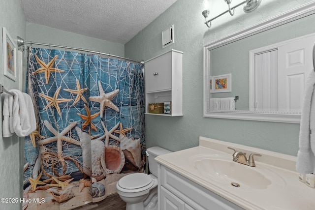 bathroom featuring a shower with shower curtain, vanity, wood-type flooring, a textured ceiling, and toilet