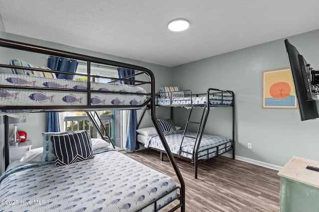 bedroom featuring hardwood / wood-style floors and a textured ceiling