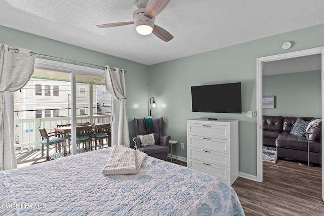 bedroom featuring ceiling fan, dark hardwood / wood-style floors, access to exterior, and a textured ceiling