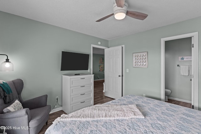 bedroom featuring ceiling fan, connected bathroom, and dark hardwood / wood-style flooring