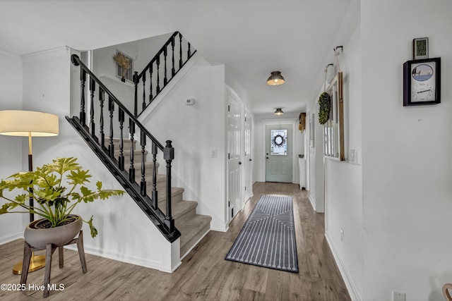 entryway with hardwood / wood-style floors