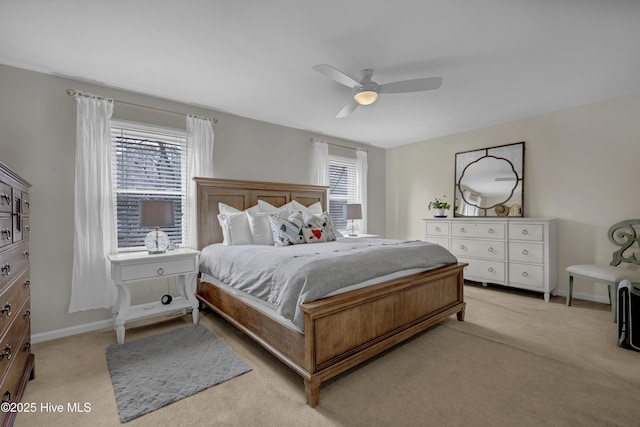 carpeted bedroom featuring ceiling fan and multiple windows