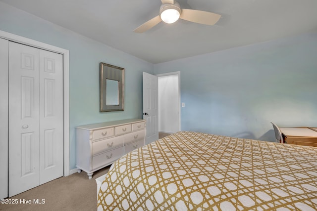 bedroom featuring ceiling fan, a closet, and light carpet