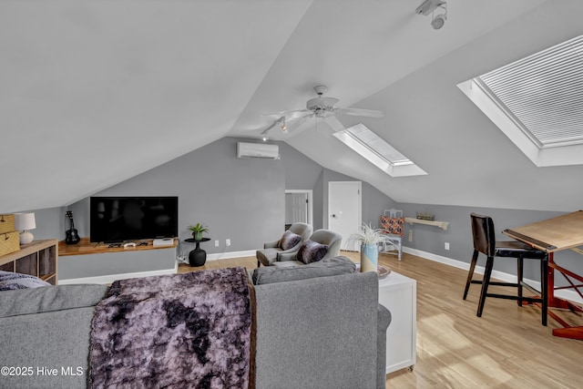 living room with lofted ceiling with skylight, a wall mounted air conditioner, light wood-type flooring, and ceiling fan