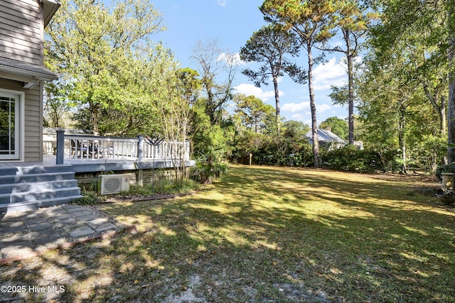 view of yard with a wooden deck and ac unit