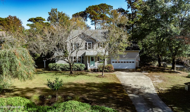 view of property with a front lawn and a garage