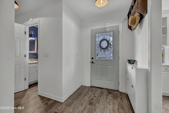 foyer featuring sink and light hardwood / wood-style flooring