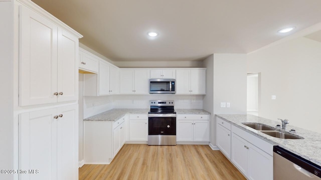 104 Bethany Pl, Goldsboro, NC 27530 - kitchen featuring light stone counters, stainless steel appliances, sink, and white cabinets