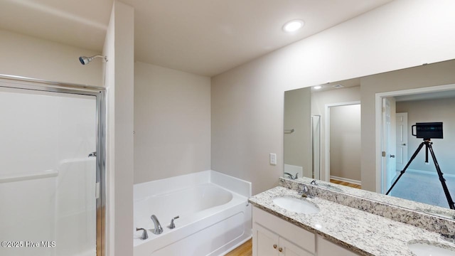 bathroom featuring vanity and separate shower and tub