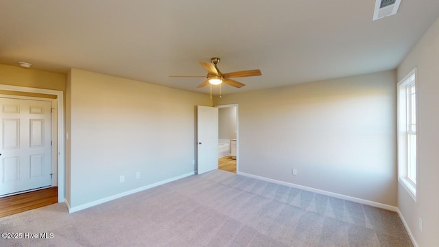 unfurnished bedroom with ceiling fan and light colored carpet