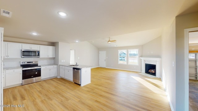 kitchen featuring white cabinetry, light hardwood / wood-style floors, kitchen peninsula, and appliances with stainless steel finishes