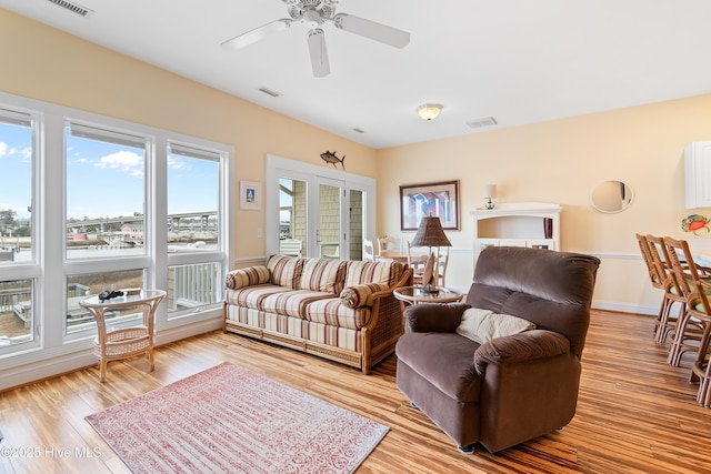 living room with ceiling fan and light wood-type flooring