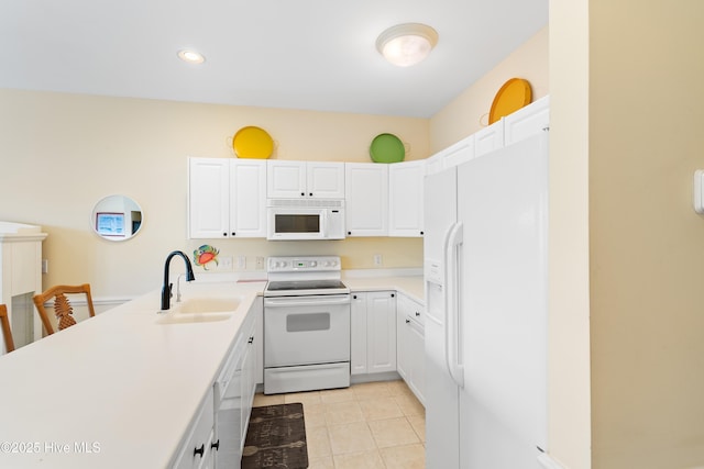 kitchen featuring white appliances, light tile patterned floors, sink, and white cabinets