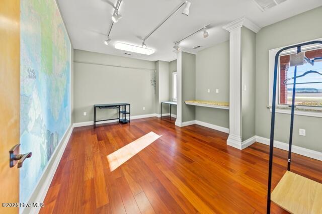 22327 NC Highway 55, Oriental, NC 28571 - interior space featuring track lighting, wood-type flooring, and decorative columns
