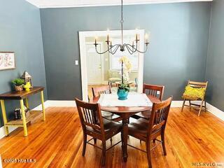 dining area with hardwood / wood-style flooring and a chandelier