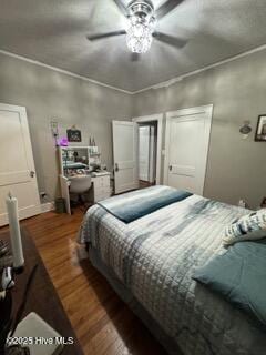 bedroom with dark wood-type flooring, ceiling fan, and ornamental molding