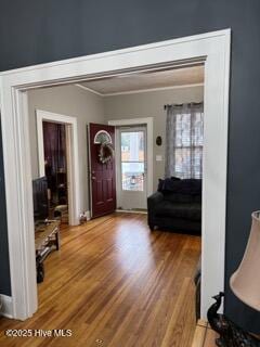 foyer with hardwood / wood-style flooring and crown molding