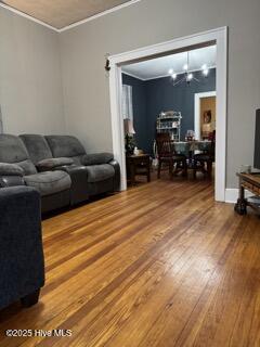 living room featuring hardwood / wood-style floors and ornamental molding