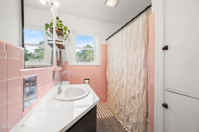 bathroom with tile walls, vanity, and a shower with shower curtain