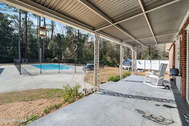 view of patio / terrace with a fenced in pool