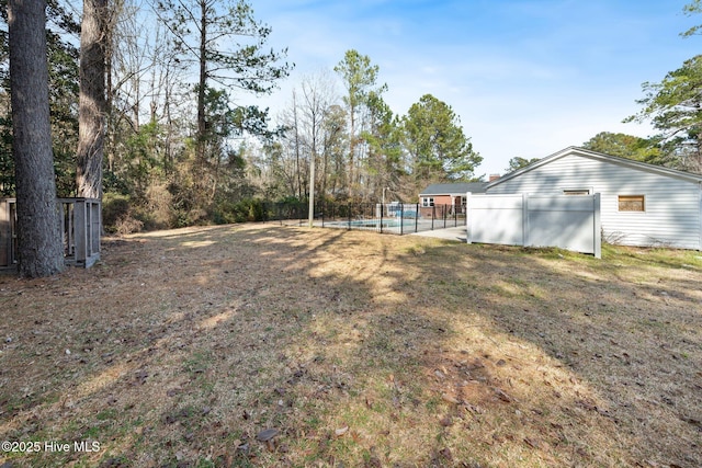 view of yard with a fenced in pool