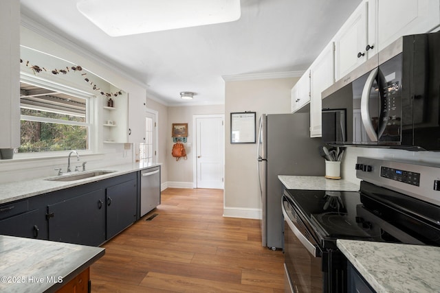 kitchen with sink, crown molding, wood-type flooring, stainless steel appliances, and white cabinets