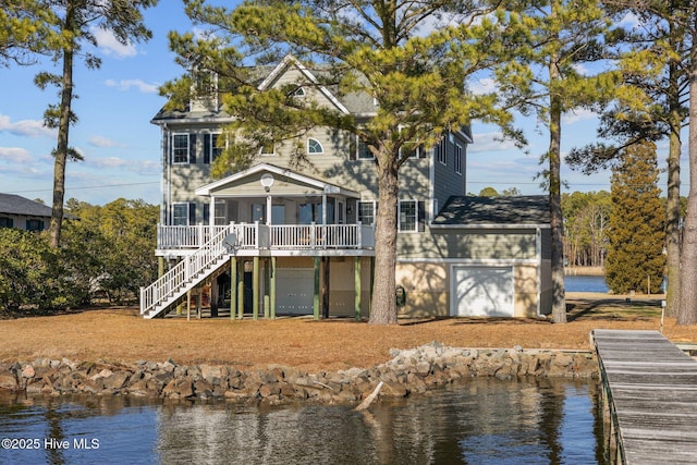 view of front of home featuring a front lawn and stairway