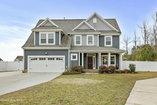 craftsman inspired home with a garage and a front lawn