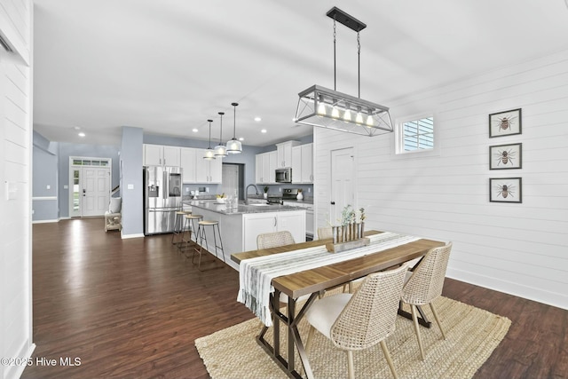 dining area with sink and dark hardwood / wood-style flooring