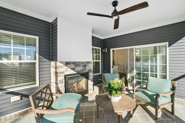 exterior space with ceiling fan and an outdoor stone fireplace