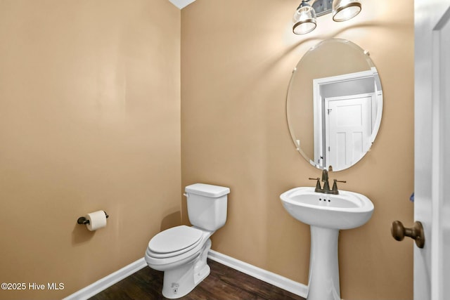 bathroom featuring wood-type flooring and toilet