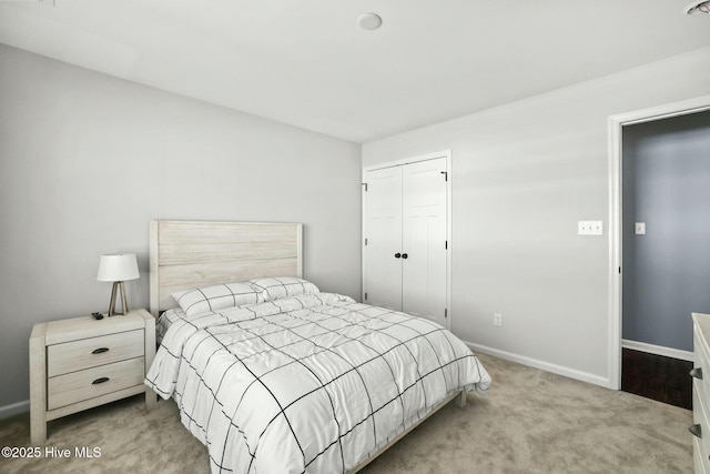 bedroom with a closet and light carpet