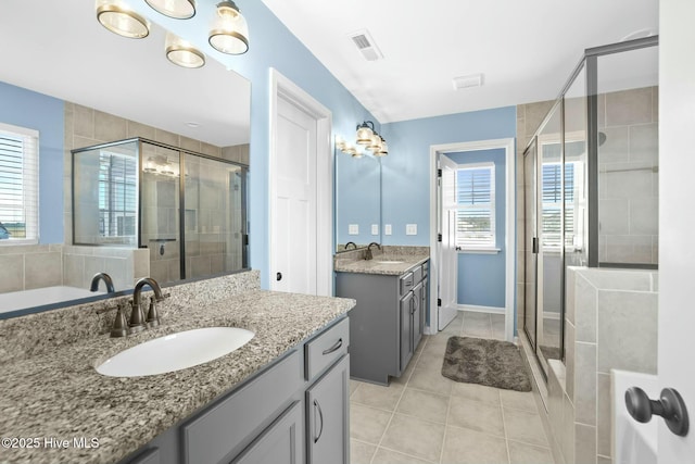 bathroom featuring vanity, an enclosed shower, and tile patterned floors