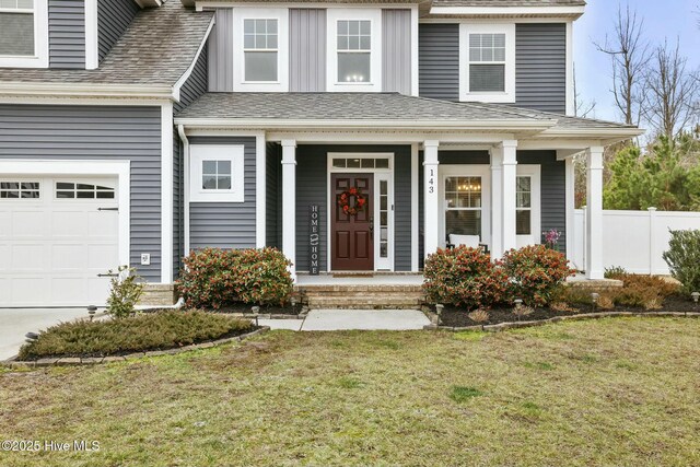 view of front of house with a garage and a front lawn