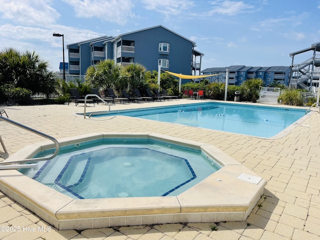 view of pool with a community hot tub