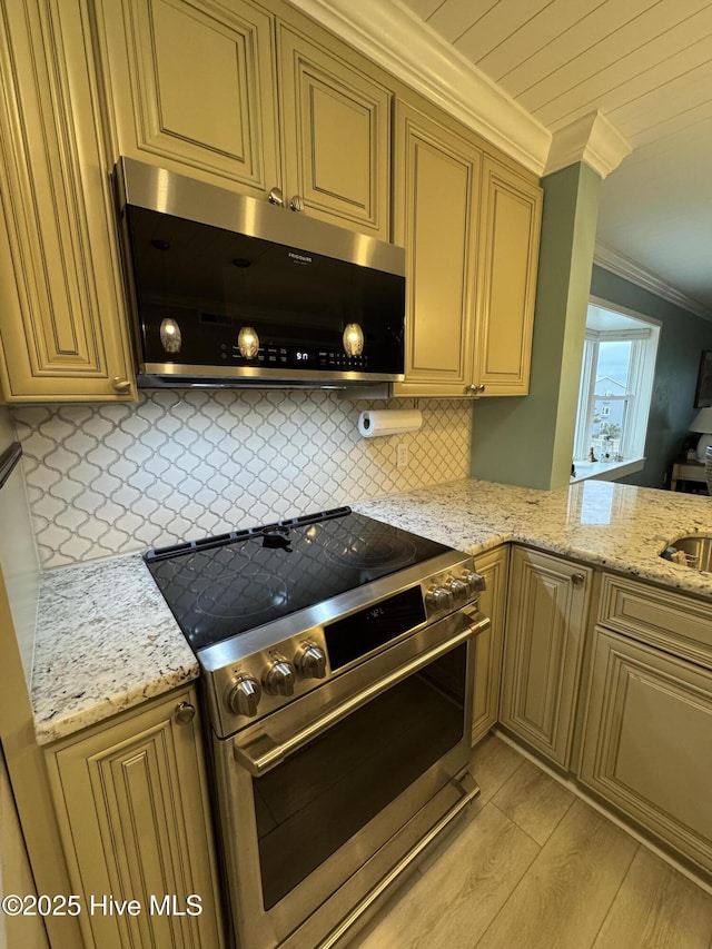 kitchen featuring light stone counters, light wood-type flooring, ornamental molding, stainless steel appliances, and backsplash