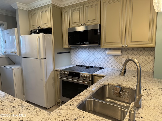 kitchen featuring cream cabinets, light stone countertops, sink, and appliances with stainless steel finishes