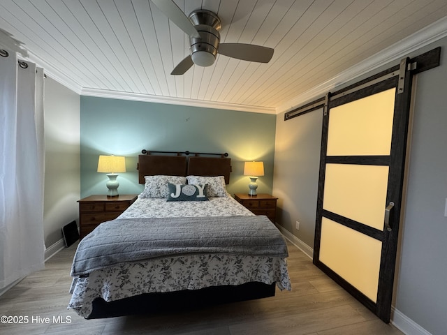 bedroom featuring ornamental molding, a barn door, wood ceiling, and light hardwood / wood-style flooring