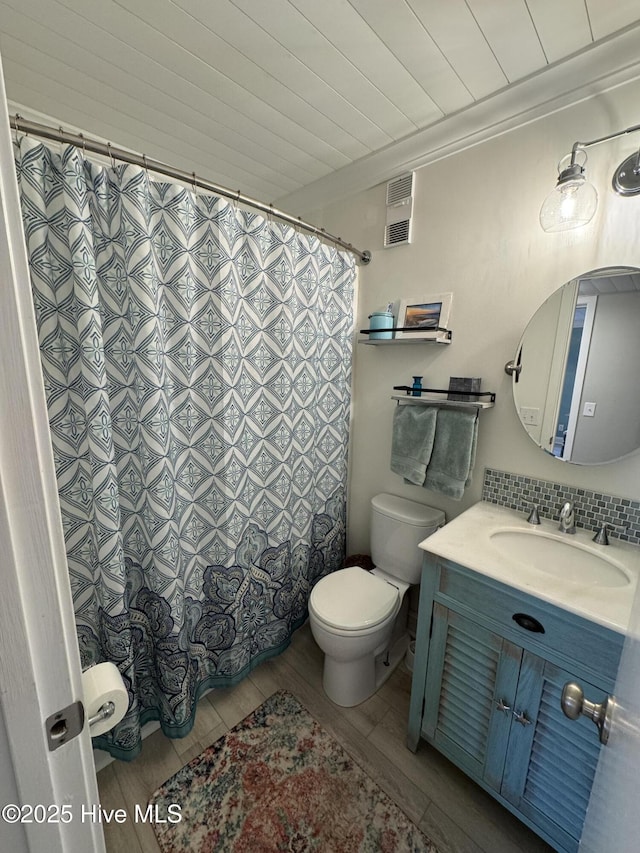 bathroom with wood-type flooring, vanity, and toilet